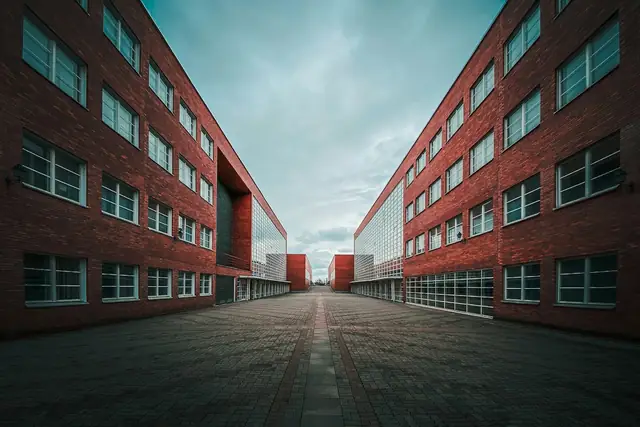 A red-brick school building under a blue sky